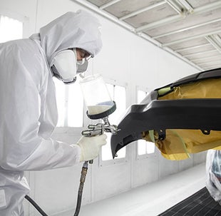 Collision Center Technician Painting a Vehicle | Fremont Toyota Lander in Lander WY