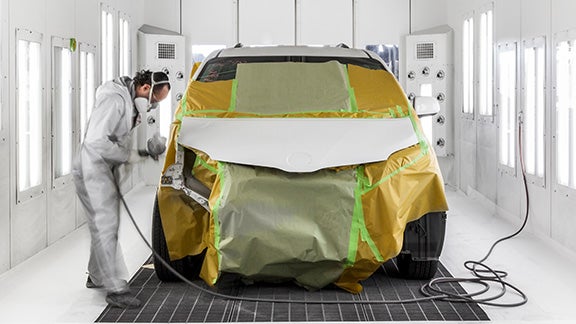 Collision Center Technician Painting a Vehicle | Fremont Toyota Lander in Lander WY