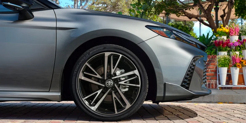 2025 Toyota Camry next to flowers