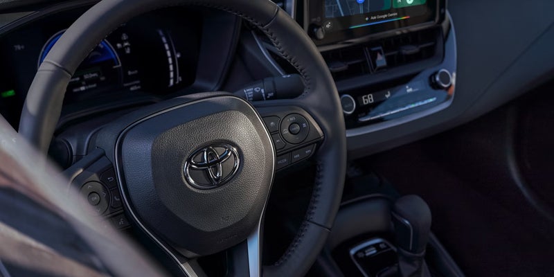 2027 Toyota Corolla steering wheel controls and driver cockpit